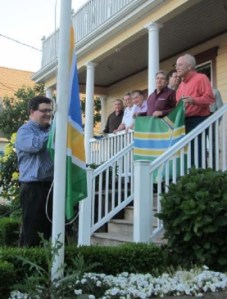 Scott Mainwaring hoists the PFA flag to start the May meeting.