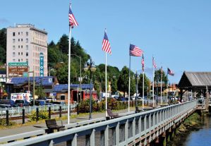 US flags fly along the Coos Bay Boardwalk.  Photo by Lou Sennick, The World.