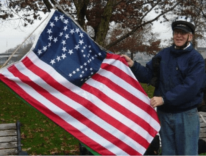 99% US flag, designed and manufactured by Peter Orenski’s TME Co.  Ted Kaye delivered this one to the Occupy Portland    protesters in early December 2011 at Salmon Street Springs.  Photo by Ted Kaye. 
