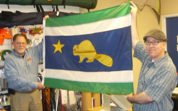 Mike Hale presents designer Randall Gray with his “new” Oregon Flag
