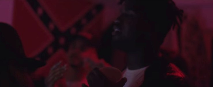 The lights are down, but a Confederate flag is on the wall.