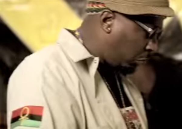 X Clan adopted the ankh or "Key of the Nile" as part of their symbology, using a version of the green, red, and black flag charged with this ancient symbol of universal life.  The video shows Brother J wearing a large gold ankh around his neck.