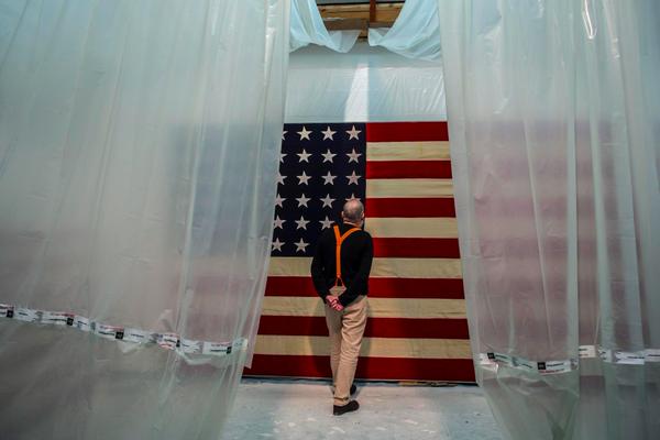 AA Bronson examines one of his flag-canvasses in process of producing the White Flag exhibit at Galerie Esther Schipper, Berlin. From his twitter feed.