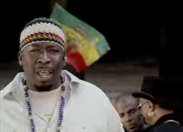 Leader Brother J with the imperial Ethiopian flag in the background.  The flag, adopted by the Rastafarians, depicts the Lion of Judah.