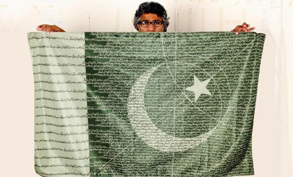 R.M Naeem and his flag with the sentence in Urdu.