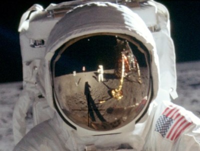 Detail of the original raw image, showing Armstrong reflected in Aldrin's visor.