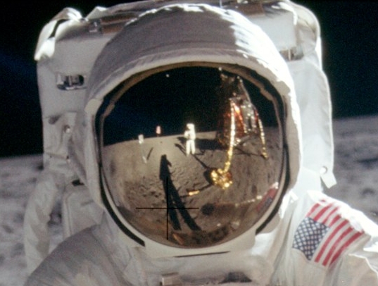 Detail of the original raw image, showing Armstrong reflected in Aldrin's visor.