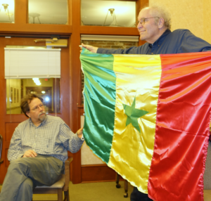 David Koski admires the Senegalese flag displayed by Michael Orelove.